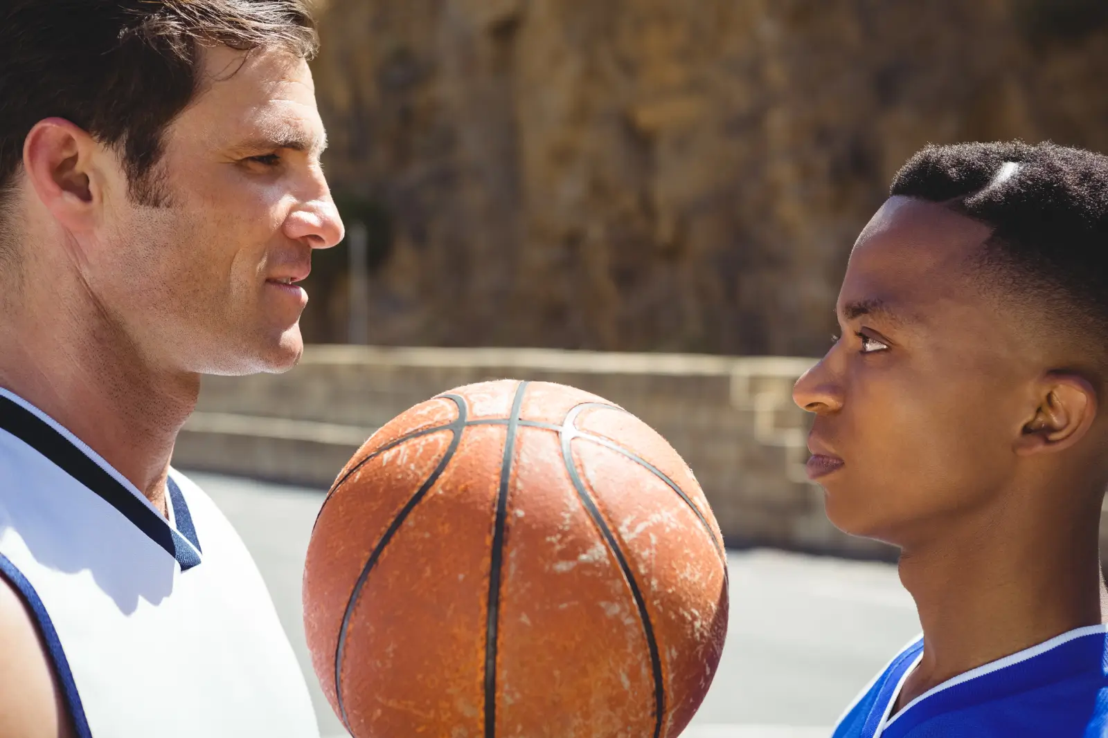 Basketball coach and player staring at one another